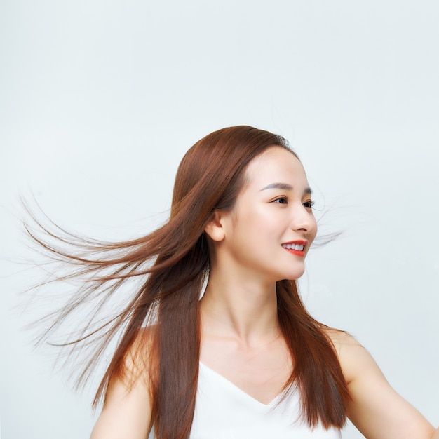 Face of the beautiful woman with long brown hair posing at studio