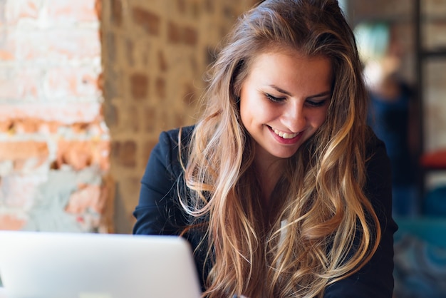 Face of beautiful woman working on a laptop