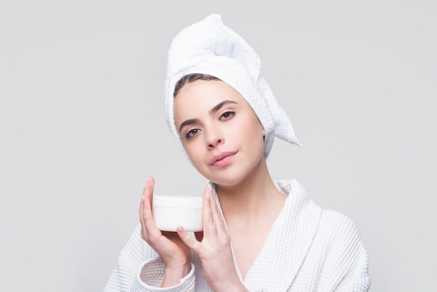 Face beauty care Portrait of beautiful woman with facial cream in hand Sexy female with fresh clean soft skin Cosmetic skincare product