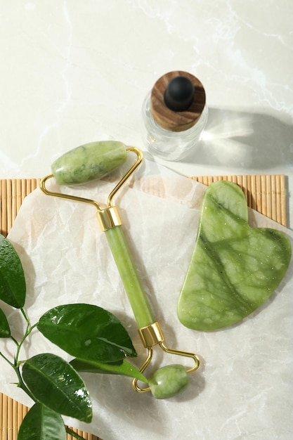 Face care concept with gua sha face roller and cosmetic