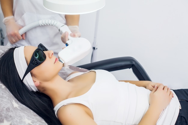 Face Care. Facial Laser Hair Removal. Beautician Giving Laser Epilation Treatment To Young Woman's Face At Beauty Clinic. Body Care. Hairless Smooth And Soft Skin. Health And Beauty Concept.