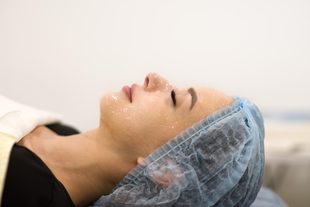 Face cleaning in a beauty salon closeup of a woman's face