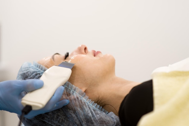 Face cleaning in a beauty salon closeup of a woman's face