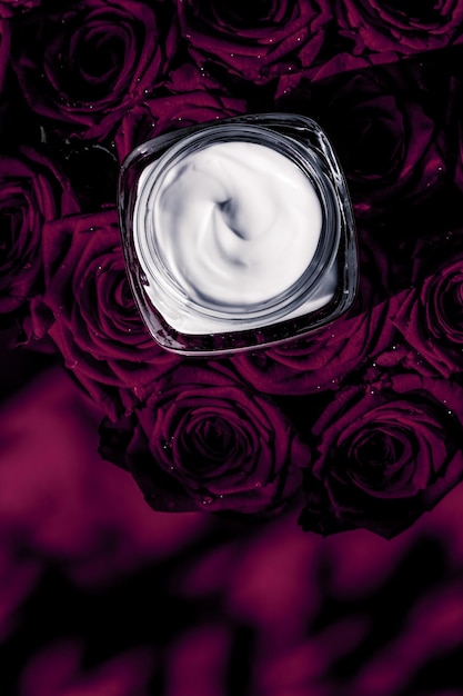 Face cream skin moisturizer and dark purple flowers luxury skincare cosmetic product on floral background as beauty brand holiday flatlay design