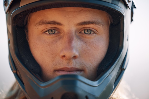 Face helmet and extreme sports with a man biker outdoor alone for adventure or adrenaline Portrait safety and motocross with a confident male rider outside alone for fun or recreation closeup