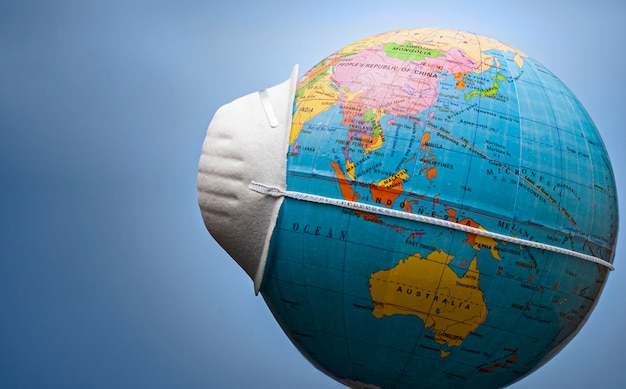 Face mask around a world globe in side view