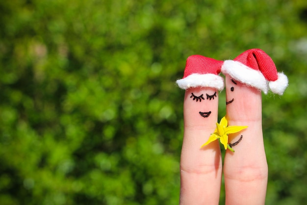 Face painted on fingers Man is giving flowers to a woman