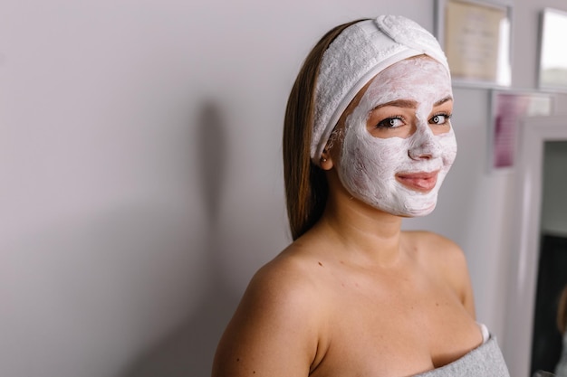 Face peeling mask spa beauty treatment skincare Woman getting facial care by beautician at spa salon