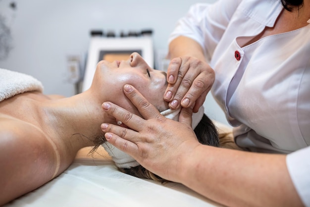 Face of satisfied client of woman lying in salon and getting high from a relaxing procedure