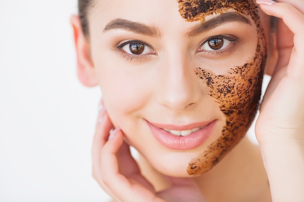 Face Skincare. Young Charming Girl Makes a Black Charcoal Mask on Her Face