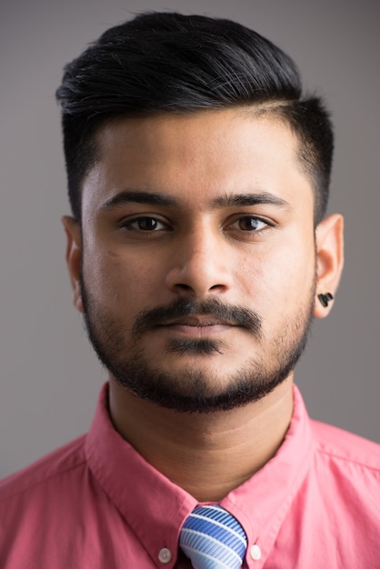 Face of young handsome Indian man