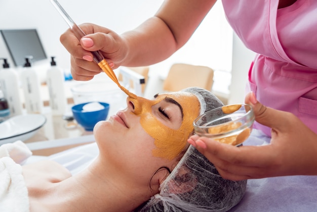 Facial cosmetic procedure in spa salon.