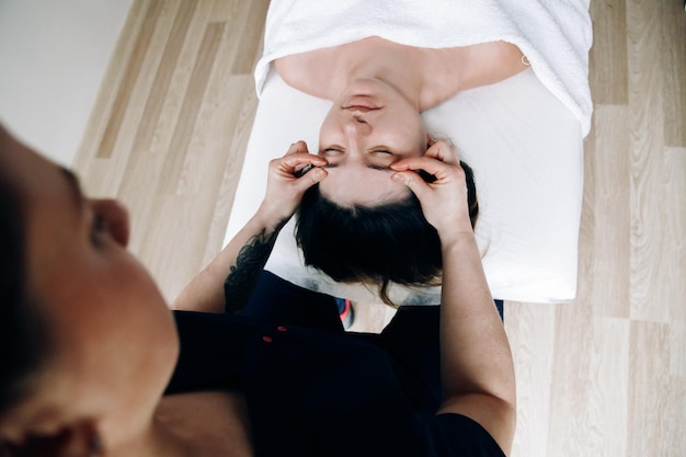 Facial massage Closeup of a woman face Massage therapist doing facial massage to a person