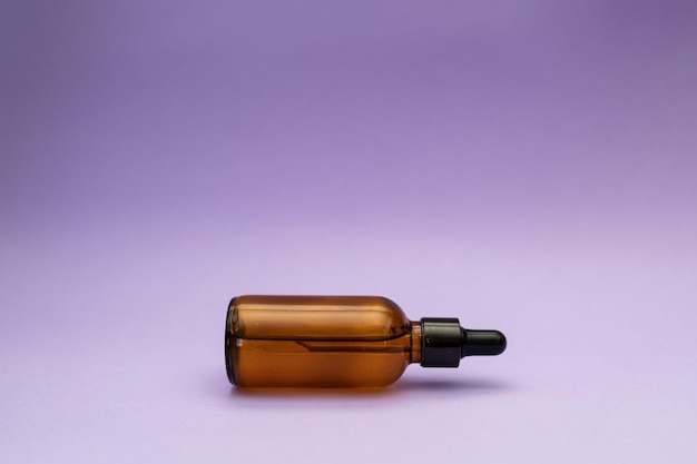 Facial serum on purple background cosmetics subject