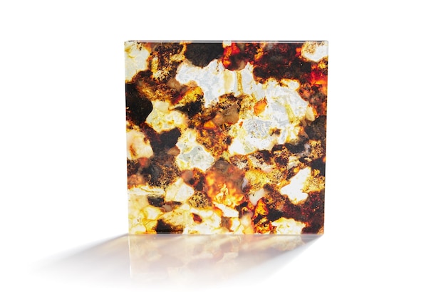 Facing tiles of different colors from amber stone with a beautiful textured pattern on a white background in the light with different angles and a shadow