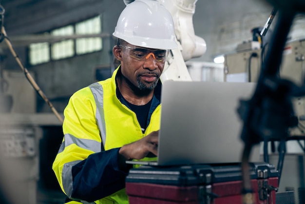 Factory worker working with laptop computer to do adept procedure checklist