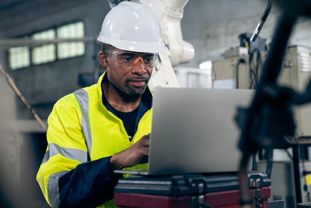 Factory worker working with laptop computer to do adept procedure checklist