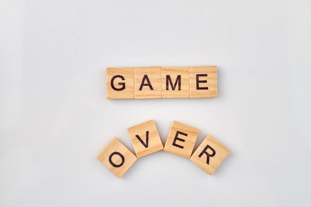 Photo failure game concept. game over text on wooden cubes isolated on a white background.