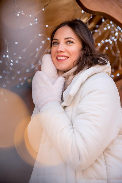 Fair girl dressed in a white jacket and a white hat the girl smiles cup of coffee in hand wooden summer house girl rejoices emotions