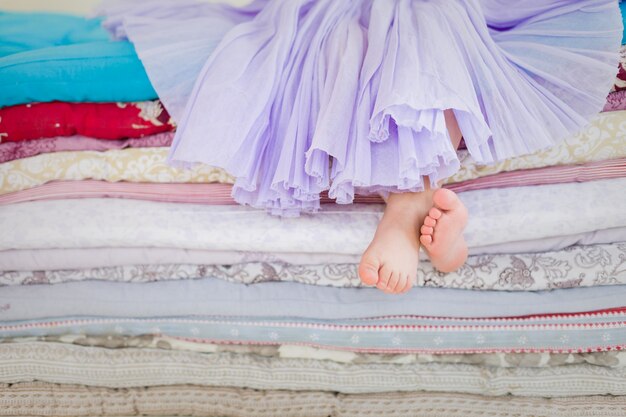 the fairy tale the princess on a pea little girl in lilac tatu skirt sitting on the high bed