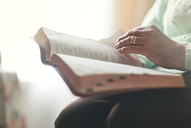 Faith comes first Closeup shot of an unrecognisable woman reading a bible