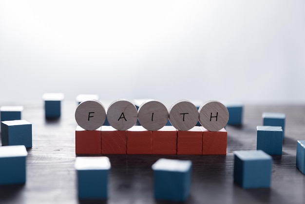 Faith symbol Turned wooden cube with words Faith Beautiful white background Business and Faith concept Copy space