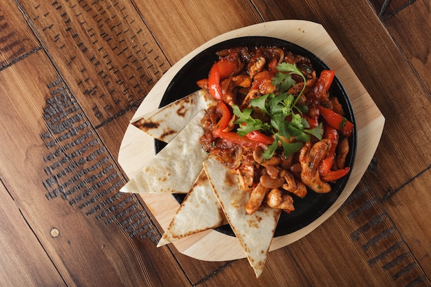 Fajitas with chicken and bell pepper in a pan