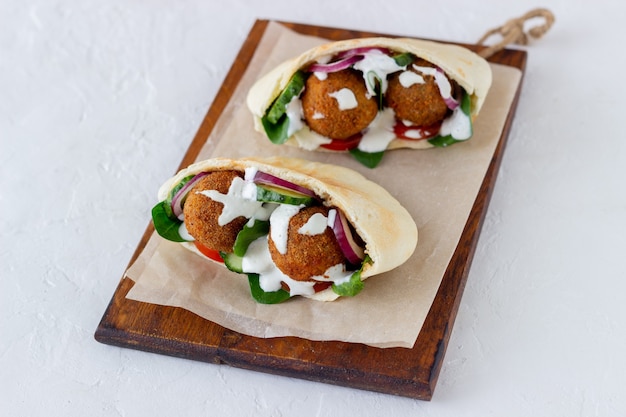 Falafel in pita with tomatoes, cucumbers, onions and spinach. Healthy eating. Vegetarian food.