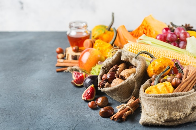 Fall autumn harvest thanksgiving background with pumpkin apple chestnut corn