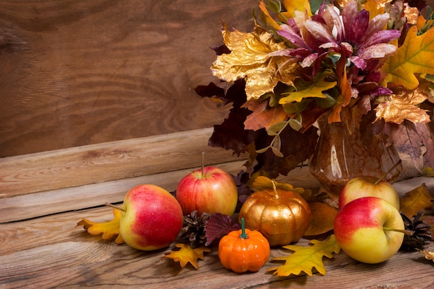 Fall centerpiece with purple flowers, golden pumpkin