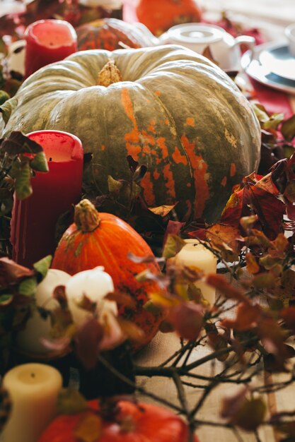 Fall thanksgiving decor with candle and pumpkins close up