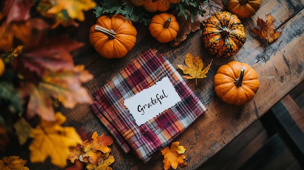 Photo fall thanksgiving table setting with pumpkins and plaid blanket