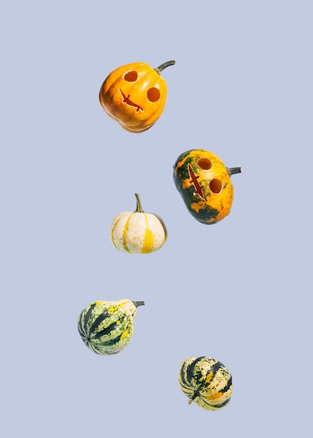 Falling Halloween pumpkins isolated on a blue background