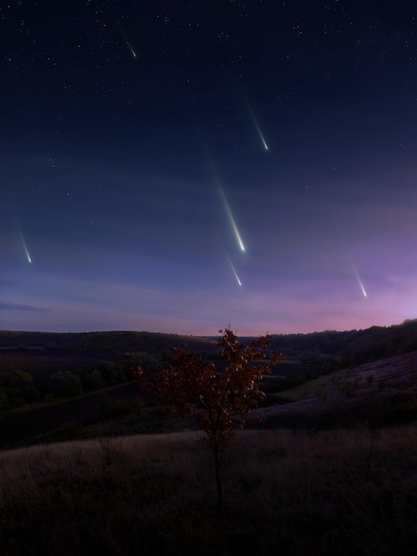 Falling meteors evening landscape Meteor shower over the hills Fireballs in the sky dreamy view