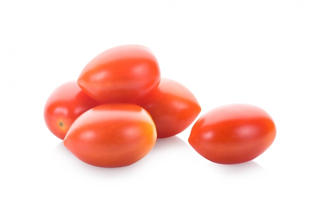 Falling plum tomatoes isolated on white wall