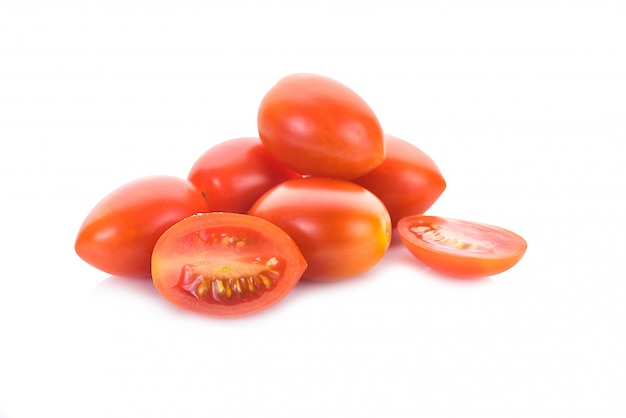 Falling plum tomatoes isolated on white wall