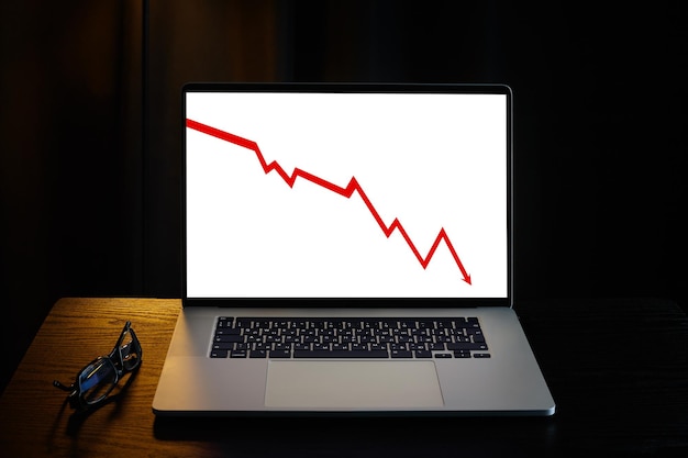 Falling red arrow or falling stock market on laptop screen