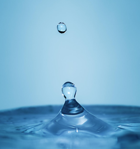 Falling water drops with splash in macro