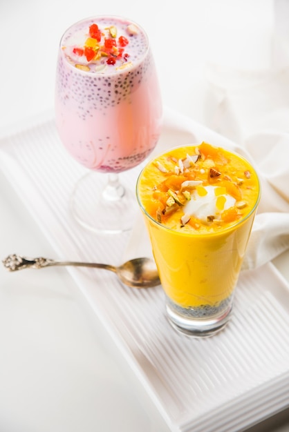 Falooda or Faluda is a popular Indian dessert - Strawberry and Mango flavoured which has Ice cream, noodles, sweet basil seeds and nuts, selective focus