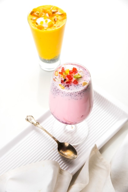 Falooda or Faluda is a popular Indian dessert - Strawberry and Mango flavoured which has Ice cream, noodles, sweet basil seeds and nuts, selective focus