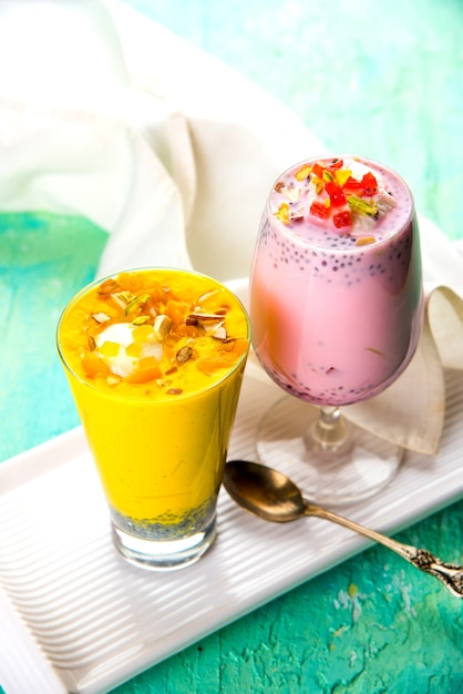 Falooda or Faluda is a popular Indian dessert - Strawberry and Mango flavoured which has Ice cream, noodles, sweet basil seeds and nuts, selective focus