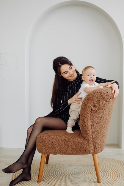 Families Portrait Of Happy Young Mother And Father with Child Posing In home Interior