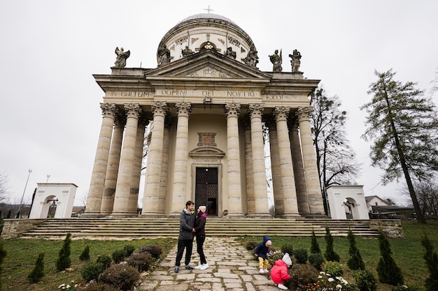 Family against baroque roman cattholic church in Pidhirtsi Lviv Oblast Ukraine