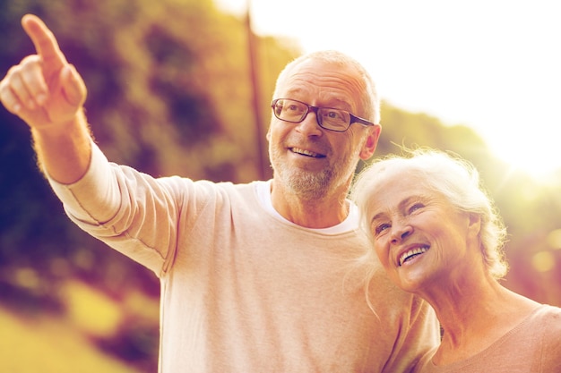 family, age, tourism, travel and people concept - senior couple in park