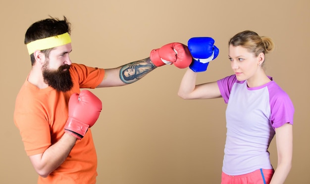 Family battle Boxing sport concept Couple girl and hipster practicing boxing Sport for everyone Amateur boxing club Equal possibilities Strength and power Man and woman in boxing gloves