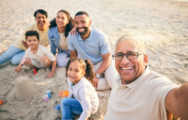 Family beach selfie and kids grandparents and portrait in sand for holiday Mexico vacation or games Play castle and happy grandmother in profile picture of mom dad and children outdoor by ocean