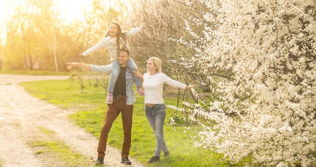 Photo family in a blooming spring garden concept of happy family