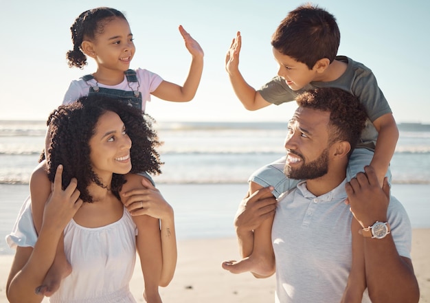 Family bond children and high five on beach holiday summer travel and fun game by ocean or sea in Mexico Smile happy and success gesture for kids with mother and father in support trust and game