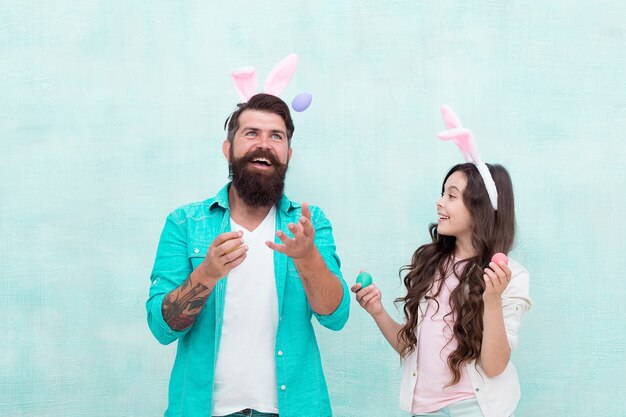 Family bonds. bunny family fun. happy family time. wearing rabbit ears for spring holiday. Daughter and father hunting eggs for Easter holiday. Having fun on Easter. Smiling father and daughter.