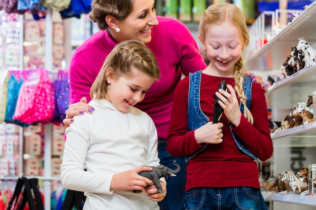 Family buying toys in toy store 